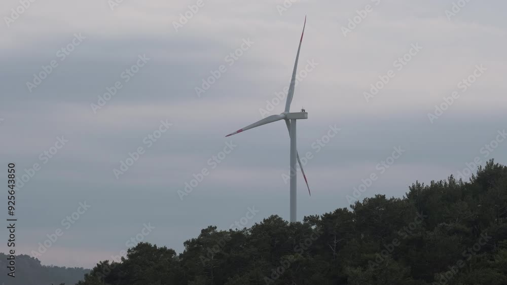 Turkey - November 10 2023: Aerial view of wind turbines spread across a landscape at sunrise, with a colorful sky and winding roads below, highlighting renewable energy in a serene setting. Turkey - November 10 2023: Aerial view of wind turbines spread across a landscape at sunrise, with a colorful sky and winding roads below, highlighting renewable energy in a serene setting.