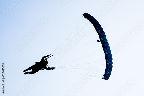 Skydiver turns to land high performance parachute silhouette 