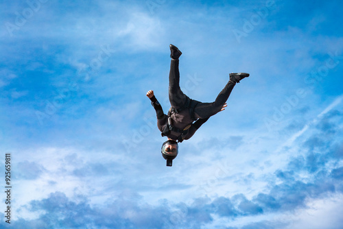 Woman skydiver falling alone in clouds