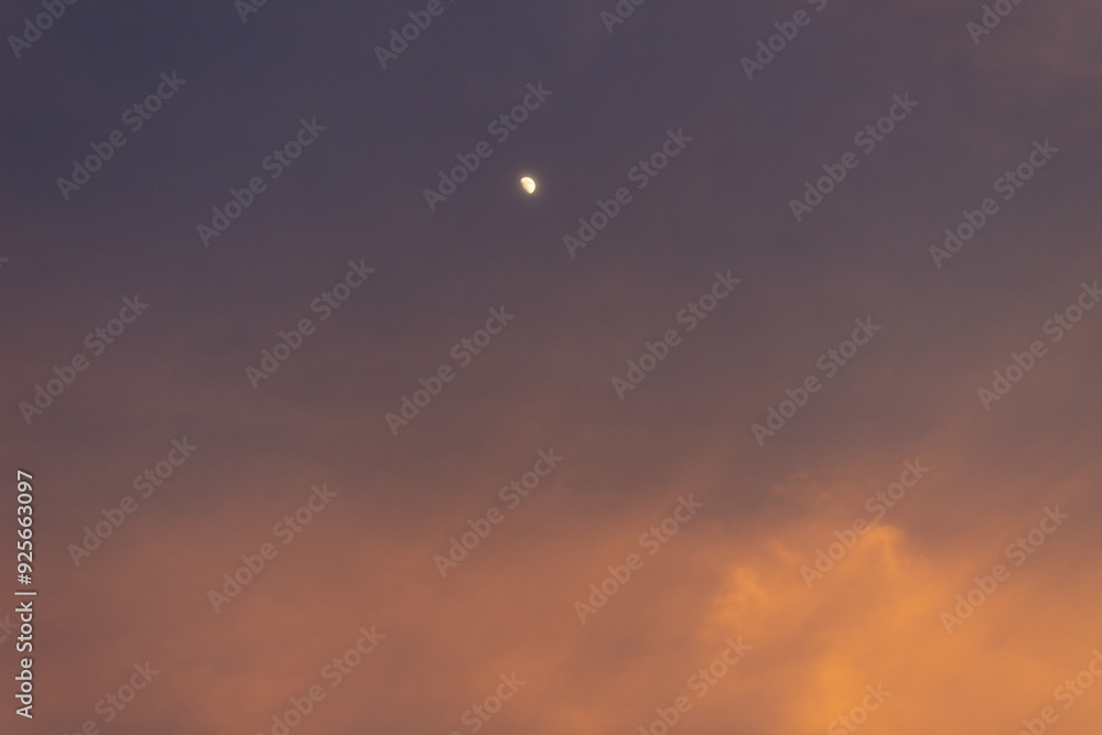 Sunset sky with clouds and the moon in the evening, nature background Sunset sky with clouds and the moon in the evening, nature background