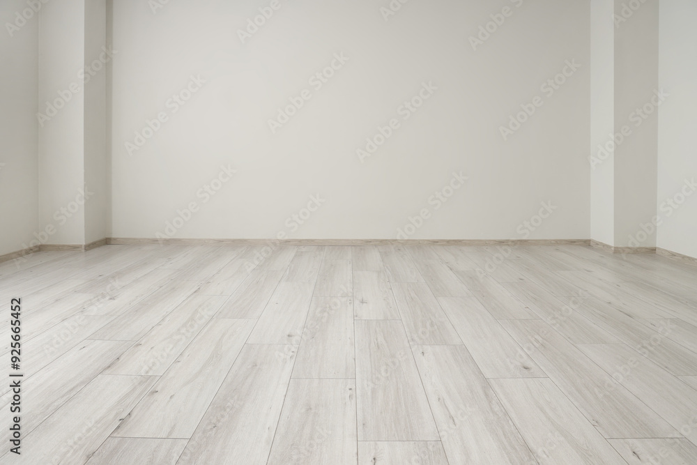 View of empty room with laminate floor and light wall View of empty room with laminate floor and light wall
