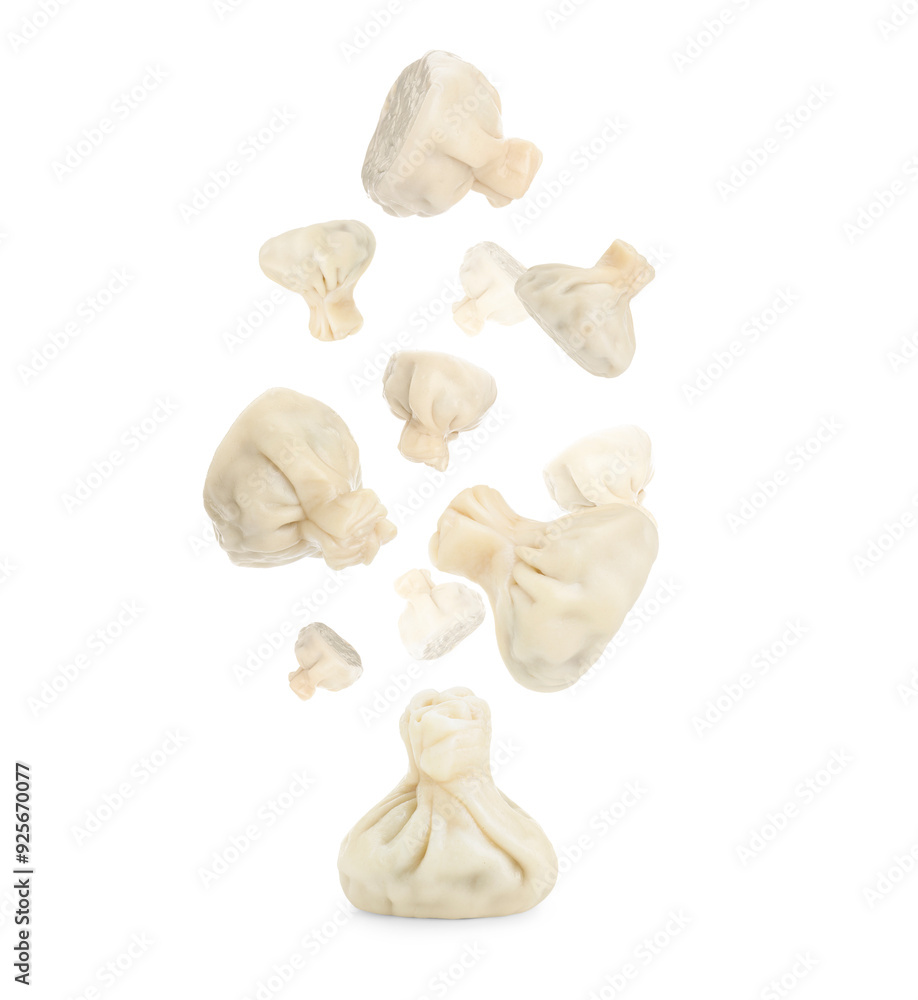 Fototapeta premium Delicious khinkali (Georgian dumplings) falling on white background