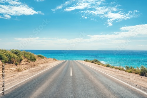 Fototapeta Naklejka Na Ścianę i Meble -  Empty asphalt road leading to ocean landscape  summer beach travel scenery with blue sky horizon