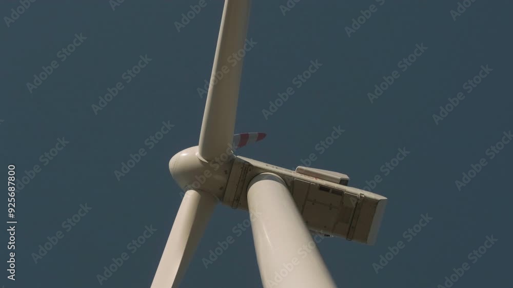 Turkey - November 10 2023: Close-up view of a wind turbine against a clear sky, capturing the details of renewable energy technology in action. Turkey - November 10 2023: Close-up view of a wind turbine against a clear sky, capturing the details of renewable energy technology in action.