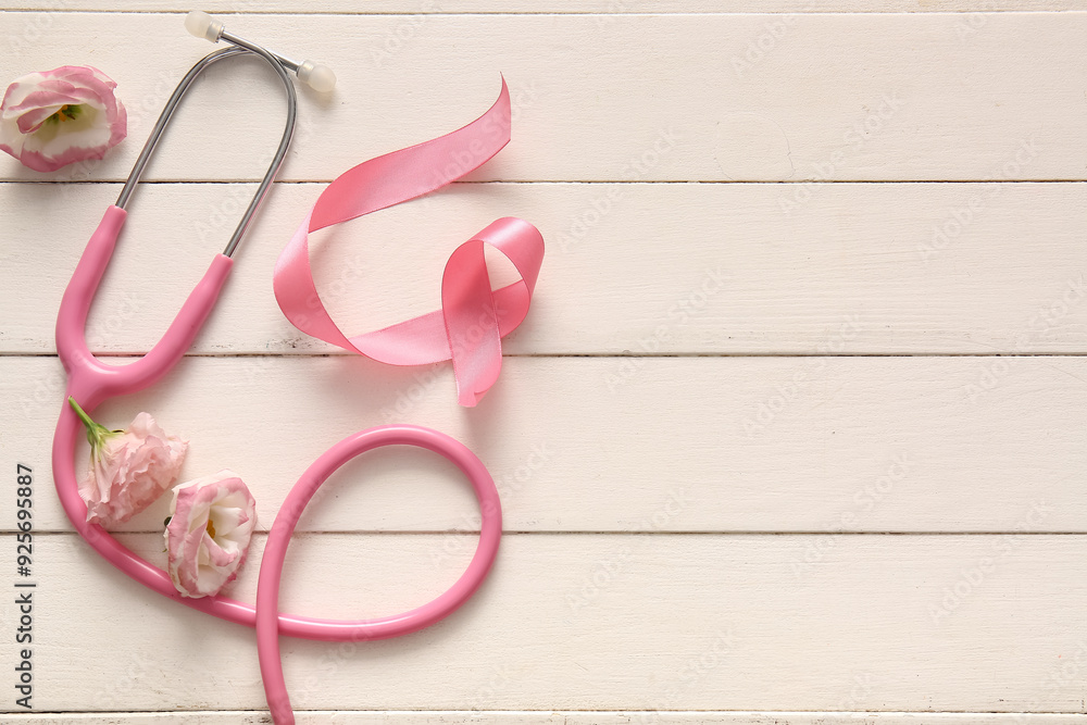 Pink ribbon, stethoscope and flowers on light wooden background. Breast cancer awareness concept Pink ribbon, stethoscope and flowers on light wooden background. Breast cancer awareness concept