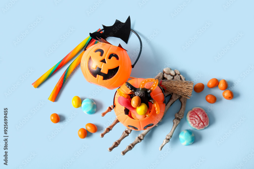 Naklejka premium Composition with tasty treats and decorations for Halloween on color background