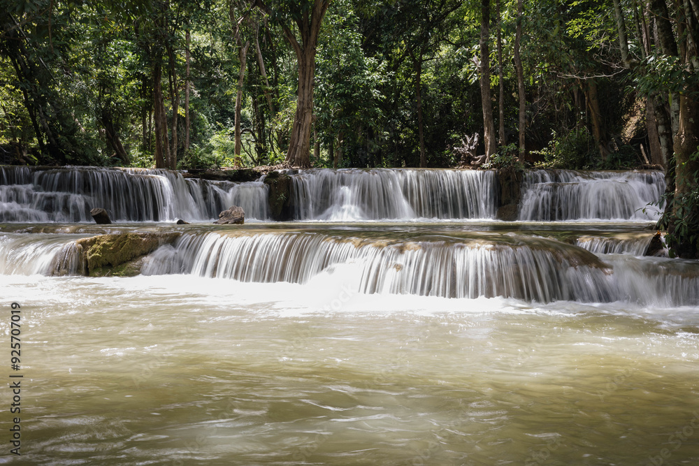 A Tranquil Scene of a Cascading Waterfall Surrounded by Lush Greenery, Capturing the Essence of Nature’s Beauty in a Peaceful Forest Setting A Tranquil Scene of a Cascading Waterfall Surrounded by Lush Greenery, Capturing the Essence of Nature’s Beauty in a Peaceful Forest Setting