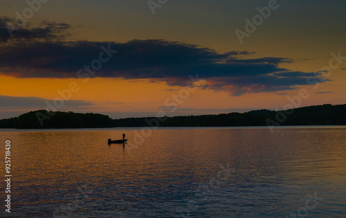 Obraz na plátně Fishing on a small boat at dusk reflected on Lake Chickamauga, Tennessee