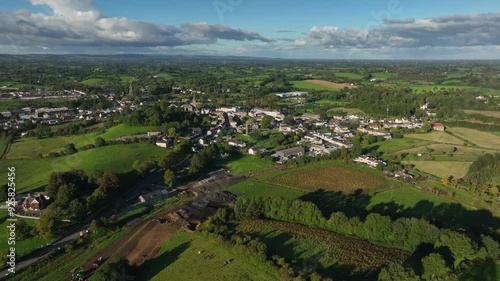 Wallpaper Mural Clones Town, County Monaghan, Ireland, April 2023. Drone pushes closer to town in a panoramic establishing overview of the Ulster Canal Restoration construction underway surrounded by green farmland. Torontodigital.ca