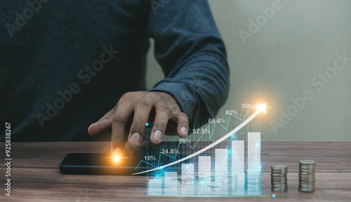 Hand young business man touching smartphone mobile with Value of money and investment for success and wealth analysis with rising graph financial photo