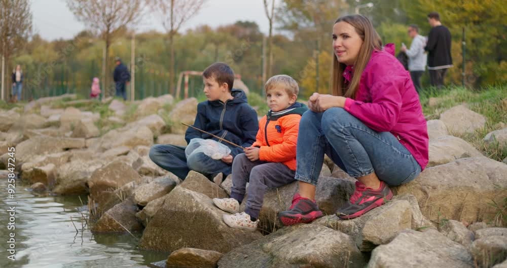 Family Enjoying Time at Rocky Lakeside Family Enjoying Time at Rocky Lakeside