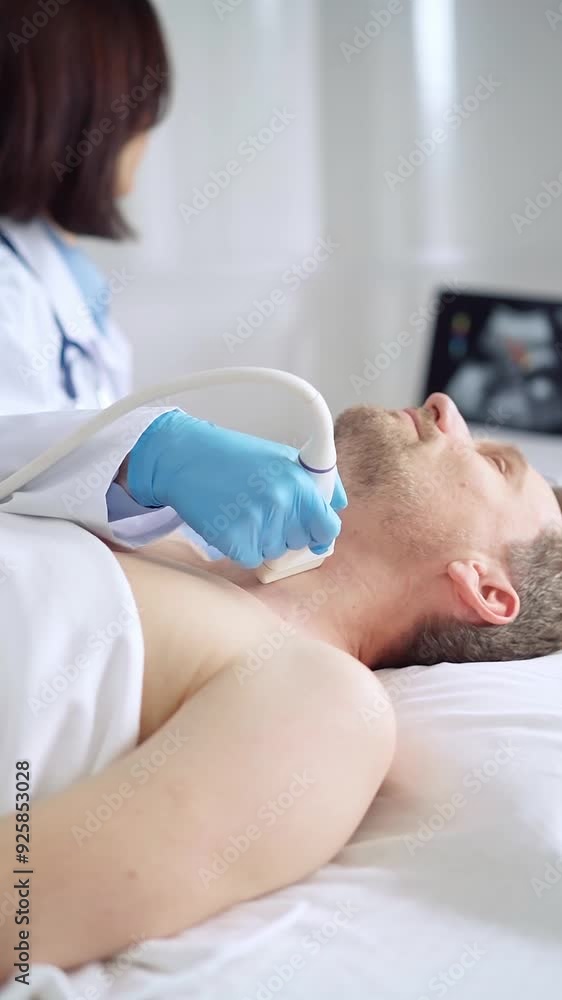 Doctor woman with blue medical gloves performing neck ultrasound exam on male patient Doctor woman with blue medical gloves performing neck ultrasound exam on male patient