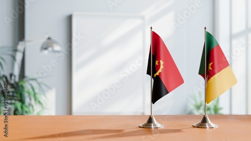 FLAGS OF ANGOLA AND CAMEROON  ON TABLE photo