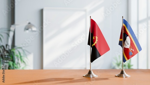 FLAGS OF ANGOLA AND ESWATINI  ON TABLE photo