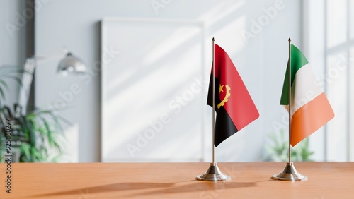 FLAGS OF ANGOLA AND IRELAND  ON TABLE photo