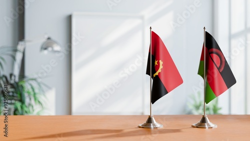 FLAGS OF ANGOLA AND MALAWI  ON TABLE photo