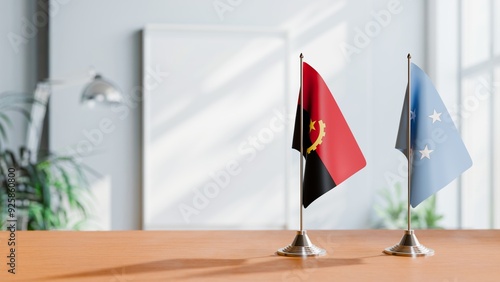 FLAGS OF ANGOLA AND MICRONESIA  ON TABLE photo