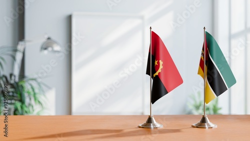 FLAGS OF ANGOLA AND MOZAMBIQUE  ON TABLE photo