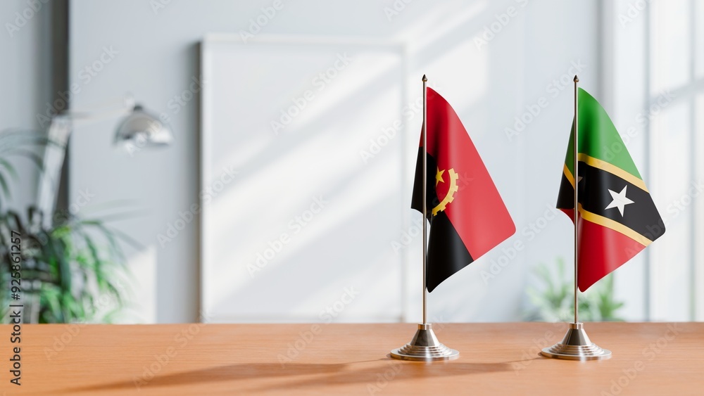 FLAGS OF ANGOLA AND SAINT KITTS ON TABLE FLAGS OF ANGOLA AND SAINT KITTS ON TABLE
