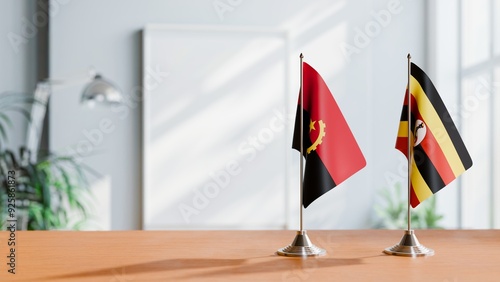 FLAGS OF ANGOLA AND UGANDA  ON TABLE photo