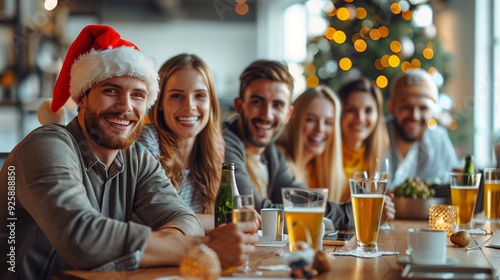 Joyful coworkers don Santa hats, ringing in the New Year at the office, toasting with champagne