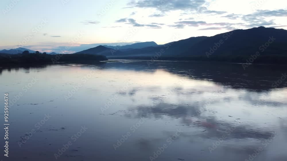 In the quiet of dusk the Mekong river cradles the night with serene embrace In the quiet of dusk the Mekong river cradles the night with serene embrace