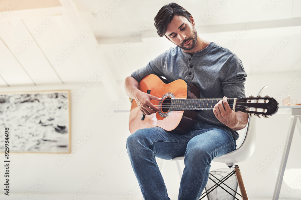 Obraz premium Playing, home and man with guitar for performance, music practice and rehearsal in living room. Entertainment, musician and person with musical instrument for audio, creative talent and writing song