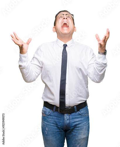 Middle age bussines arab man wearing glasses over isolated background crazy and mad shouting and yelling with aggressive expression and arms raised. Frustration concept.