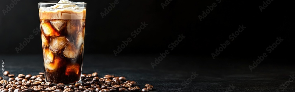 Iced coffee with cream and coffee beans on a dark background Iced coffee with cream and coffee beans on a dark background