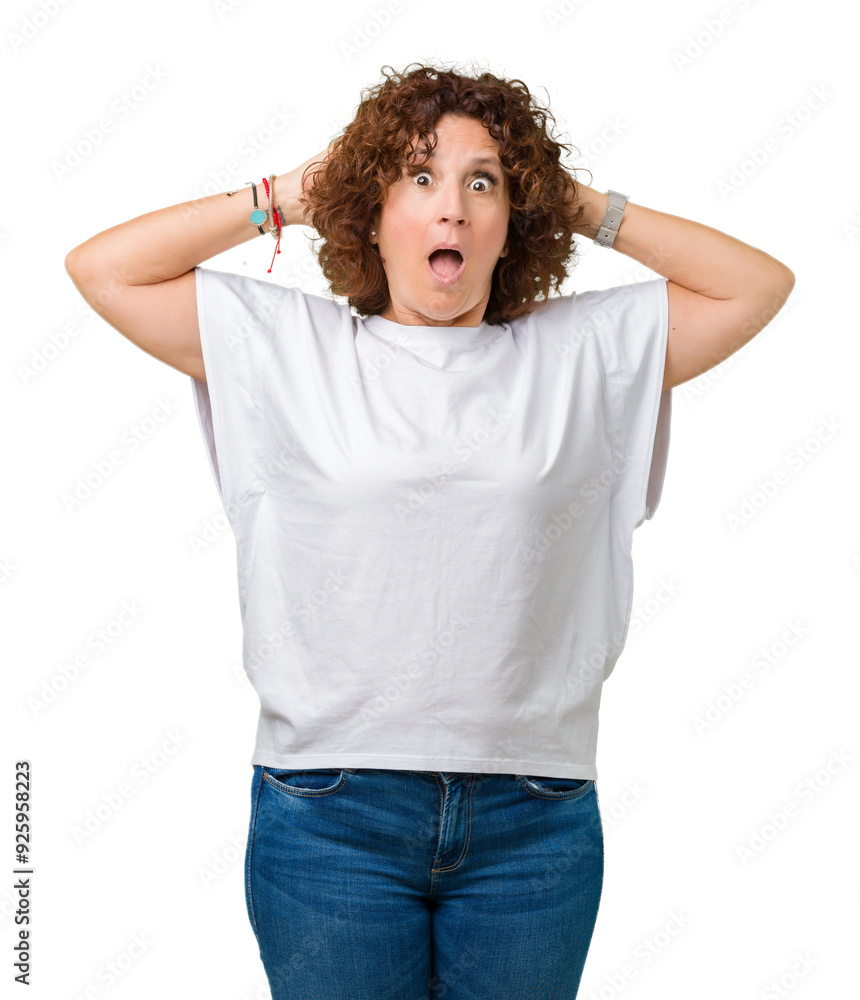 Beautiful middle ager senior woman wearing white t-shirt over isolated background Crazy and scared with hands on head, afraid and surprised of shock with open mouth Beautiful middle ager senior woman wearing white t-shirt over isolated background Crazy and scared with hands on head, afraid and surprised of shock with open mouth