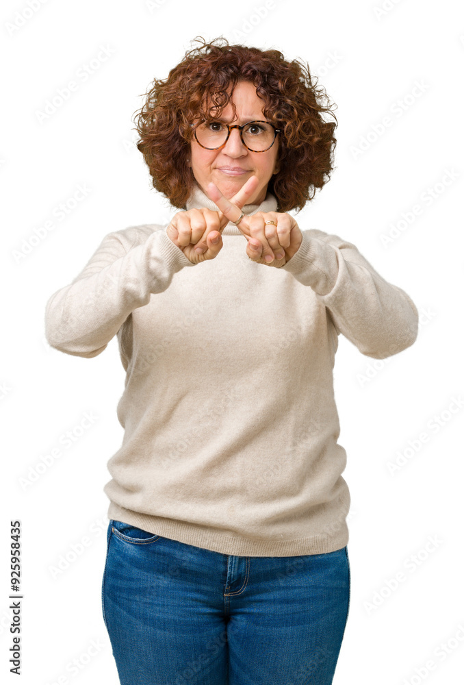 Beautiful middle ager senior woman wearing turtleneck sweater and glasses over isolated background Rejection expression crossing fingers doing negative sign Beautiful middle ager senior woman wearing turtleneck sweater and glasses over isolated background Rejection expression crossing fingers doing negative sign