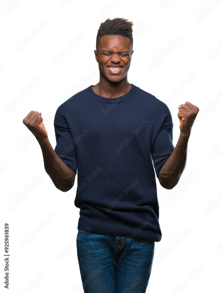 Young african american man over isolated background celebrating surprised and amazed for success with arms raised and open eyes. Winner concept. Young african american man over isolated background celebrating surprised and amazed for success with arms raised and open eyes. Winner concept.