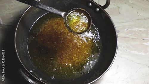 Making of Ghee known as clarified butter by heating milk cream. photo