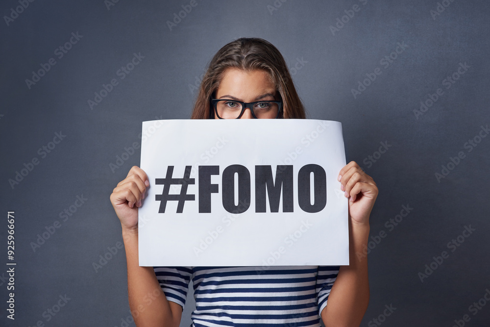 Poster, eyes and portrait of woman in studio for information, text and advertising of anxiety. Paper, embarrassed and female person with statement on gray background for fomo, insecurity and worry Poster, eyes and portrait of woman in studio for information, text and advertising of anxiety. Paper, embarrassed and female person with statement on gray background for fomo, insecurity and worry