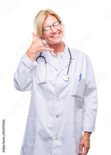 Middle age blonde doctor woman over isolated background smiling doing phone gesture with hand and fingers like talking on the telephone. Communicating concepts.