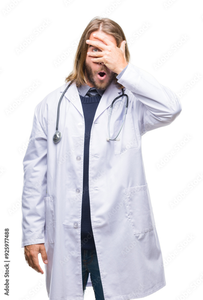 Young handsome doctor man with long hair over isolated background peeking in shock covering face and eyes with hand, looking through fingers with embarrassed expression. Young handsome doctor man with long hair over isolated background peeking in shock covering face and eyes with hand, looking through fingers with embarrassed expression.