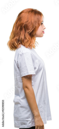 Young beautiful woman over isolated background looking to side, relax profile pose with natural face with confident smile.