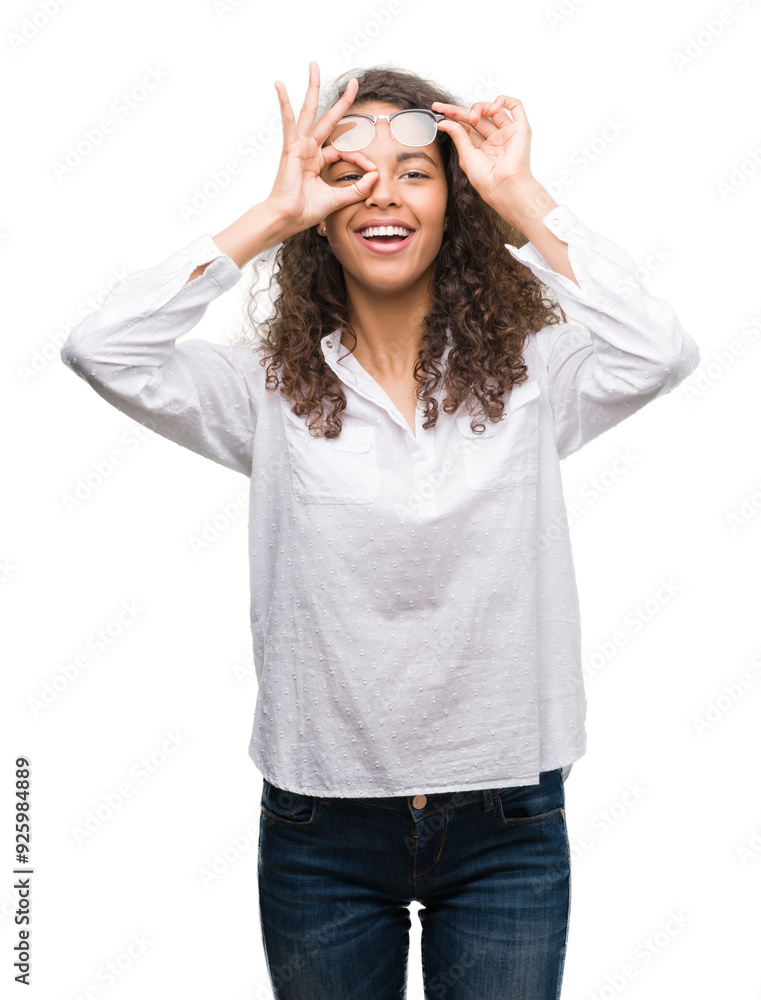 Beautiful young hispanic woman doing ok gesture with hand smiling, eye looking through fingers with happy face. Beautiful young hispanic woman doing ok gesture with hand smiling, eye looking through fingers with happy face.