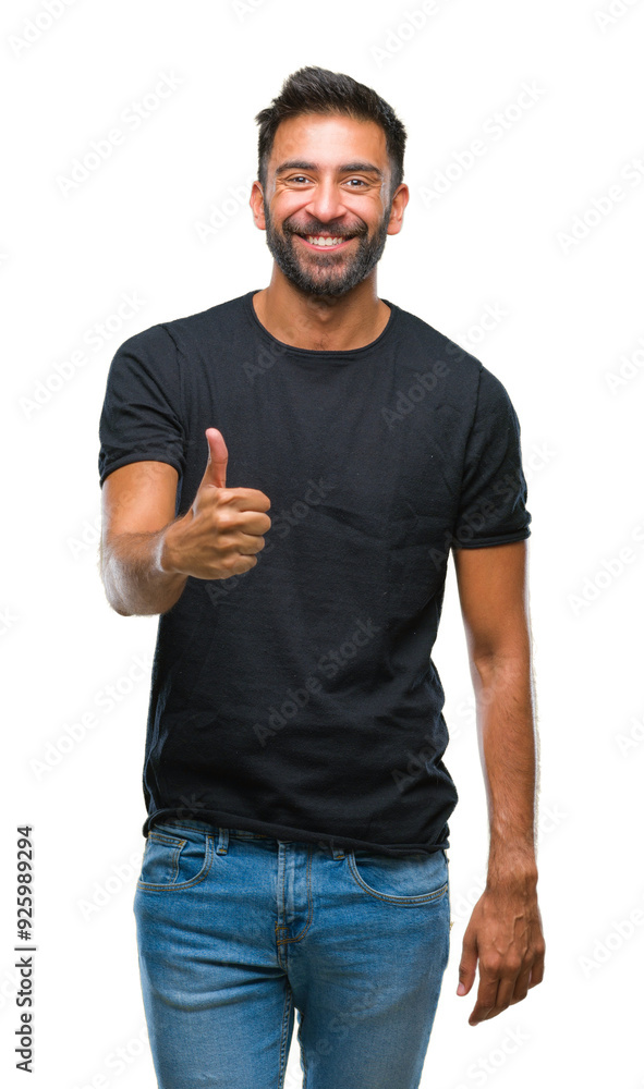 Adult hispanic man over isolated background doing happy thumbs up gesture with hand. Approving expression looking at the camera with showing success. Adult hispanic man over isolated background doing happy thumbs up gesture with hand. Approving expression looking at the camera with showing success.