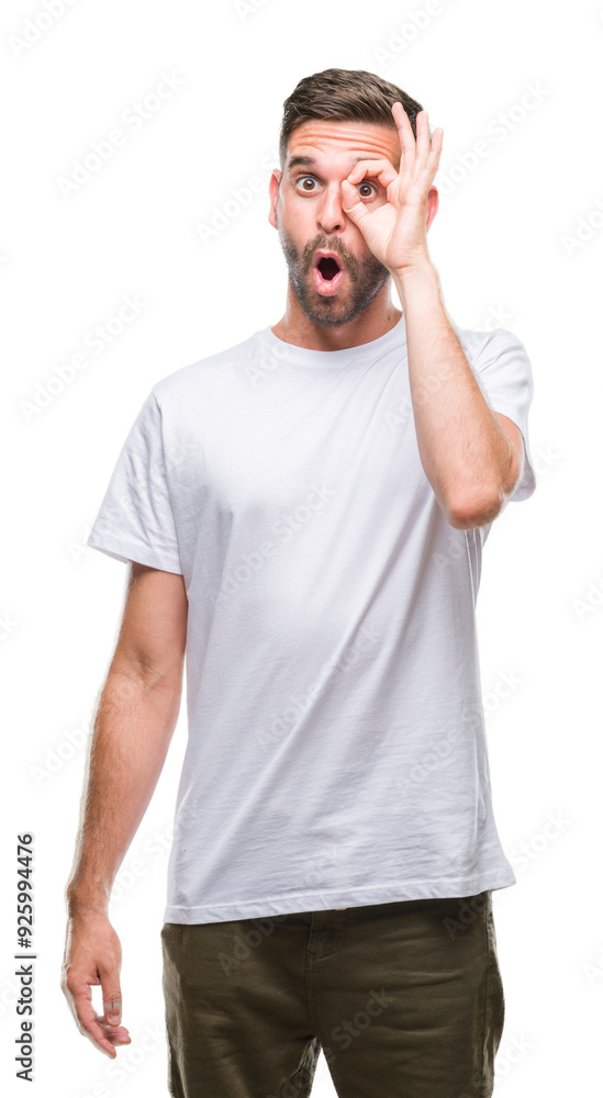 Young handsome man over isolated background doing ok gesture shocked with surprised face, eye looking through fingers. Unbelieving expression. Young handsome man over isolated background doing ok gesture shocked with surprised face, eye looking through fingers. Unbelieving expression.