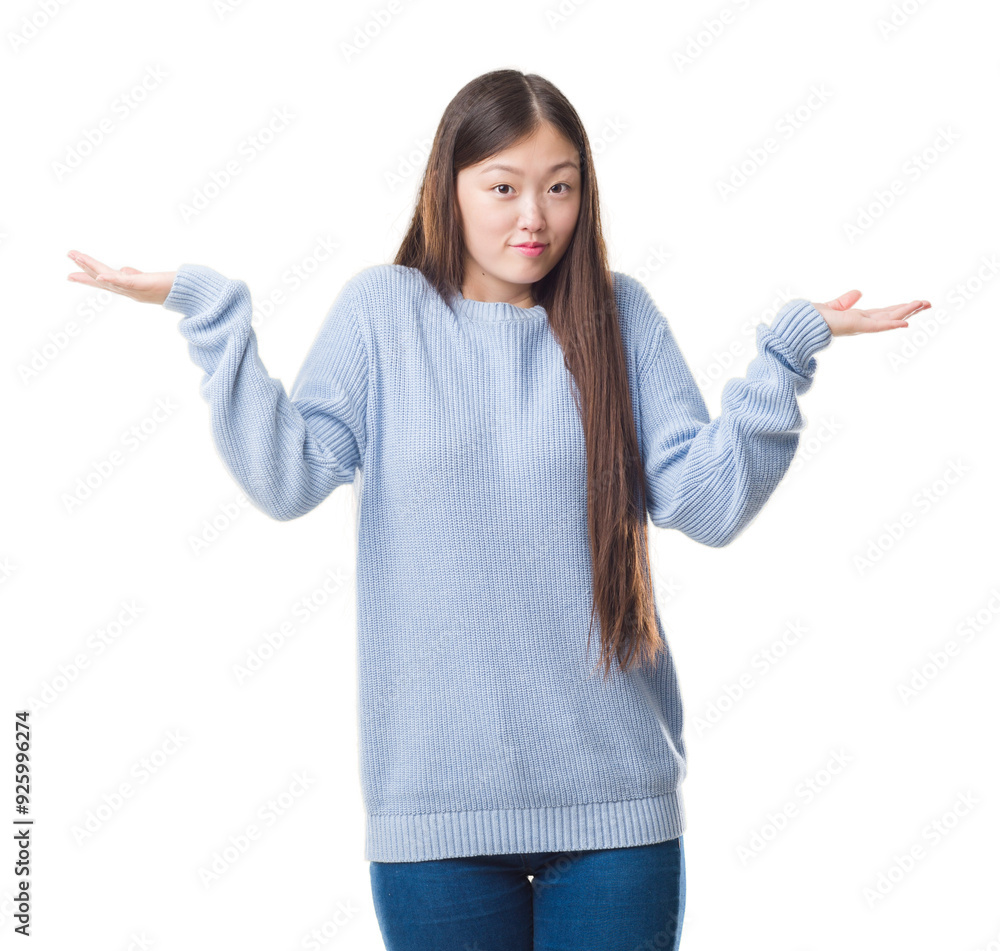 Young Chinese woman over isolated background clueless and confused expression with arms and hands raised. Doubt concept. Young Chinese woman over isolated background clueless and confused expression with arms and hands raised. Doubt concept.