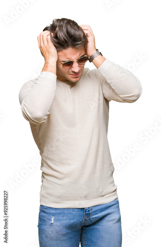 Fotografie Young handsome man wearing sunglasses over isolated background suffering from headache desperate and stressed because pain and migraine