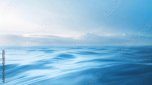 Serene Ocean Panorama: A breathtaking view of a calm ocean under a soft, hazy sky. The tranquil scene evokes peace and serenity. 