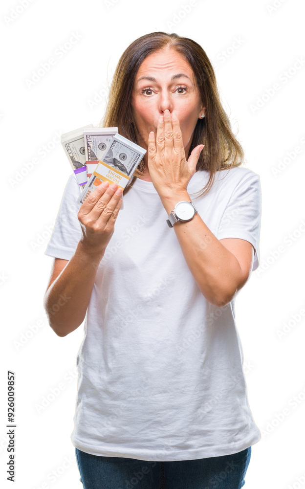 Middle age hispanic woman holding bunch of dollars over isolated background cover mouth with hand shocked with shame for mistake, expression of fear, scared in silence, secret concept Middle age hispanic woman holding bunch of dollars over isolated background cover mouth with hand shocked with shame for mistake, expression of fear, scared in silence, secret concept