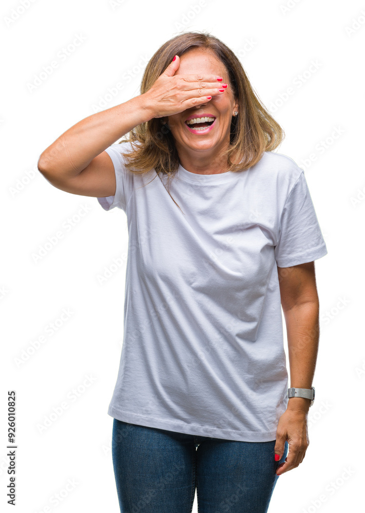 Fototapeta premium Middle age senior hispanic woman over isolated background smiling and laughing with hand on face covering eyes for surprise. Blind concept.