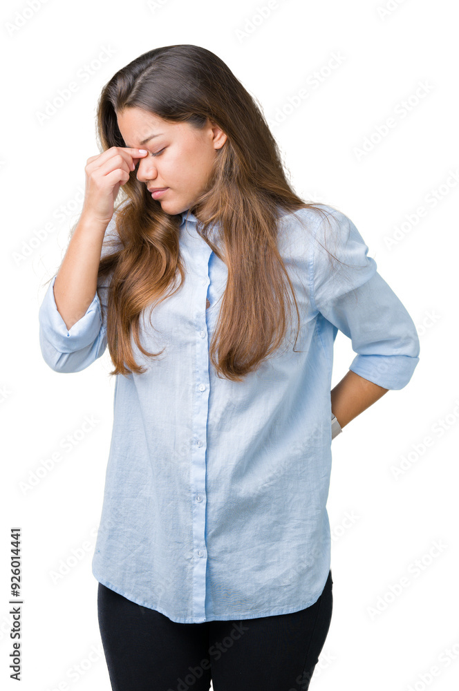 Young beautiful brunette business woman over isolated background tired rubbing nose and eyes feeling fatigue and headache. Stress and frustration concept. Young beautiful brunette business woman over isolated background tired rubbing nose and eyes feeling fatigue and headache. Stress and frustration concept.