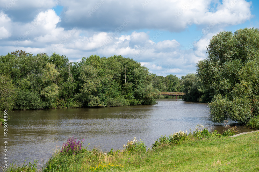 Fototapeta premium Green banks of the River Ochtum at the Kladdinger Wiesen at the borders of Bremen, Germany