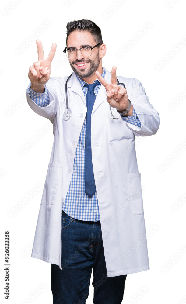 Handsome young doctor man over isolated background smiling looking to the camera showing fingers doing victory sign. Number two. Handsome young doctor man over isolated background smiling looking to the camera showing fingers doing victory sign. Number two.