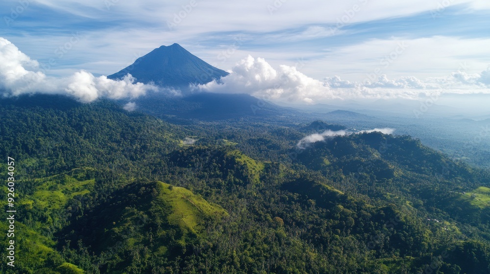 Aerial View of a Lush Green Mountain Range with a Majestic Peak Rising Above the Clouds Aerial View of a Lush Green Mountain Range with a Majestic Peak Rising Above the Clouds