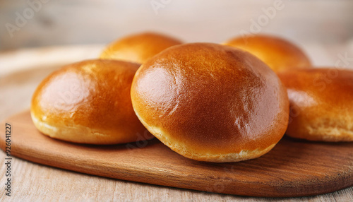 Soft dinner buns on wooden board. Tasty and fresh bakery. Culinary concept. Delicious food.